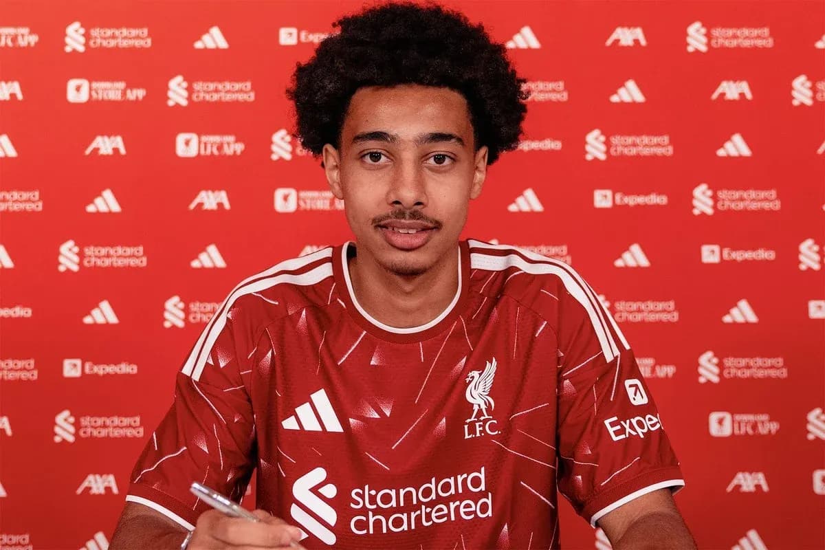 Player signing contract in Liverpool jersey at event Player signing contract in Liverpool jersey at event